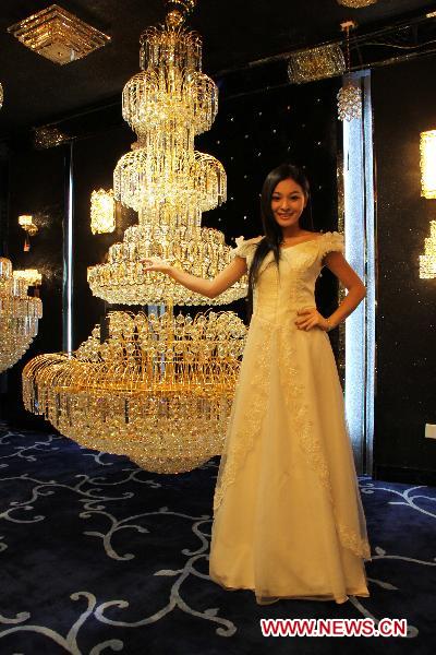 A model displays a set of crystal lamps at a luminaires cultural festival in Shantou, south China's Guangdong Province, Sept. 18, 2010. The Shantou Luminaires Cultural Festival opened here Saturday, exhibiting various kinds of lamps.