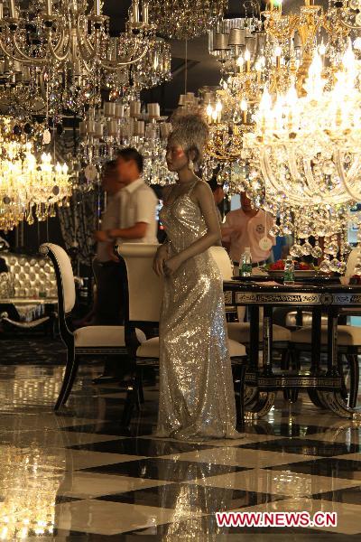 A model displays crystal lamps at a luminaires cultural festival in Shantou, south China's Guangdong Province, Sept. 18, 2010. The Shantou Luminaires Cultural Festival opened here Saturday, exhibiting various kinds of lamps.