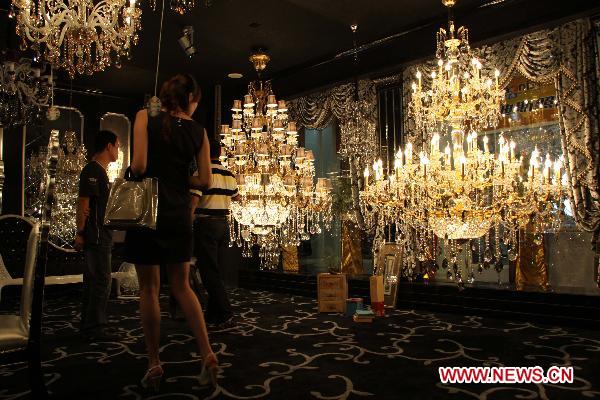 Visitors look at lamps at a luminaires cultural festival in Shantou, south China's Guangdong Province, Sept. 18, 2010. The Shantou Luminaires Cultural Festival opened here Saturday, exhibiting various kinds of lamps.