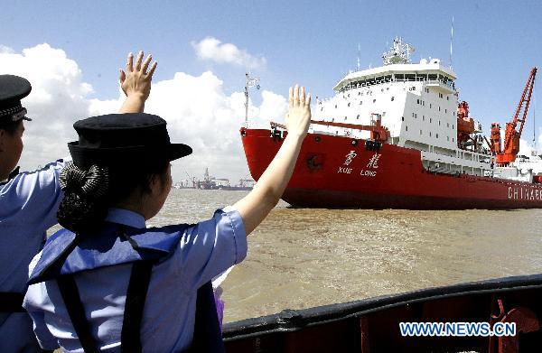Frontier police wave to welcome the China&apos;s icebreaker &apos;Xuelong,&apos; or &apos;Snow Dragon,&apos; in Shanghai, east China, Sept. 19, 2010. 