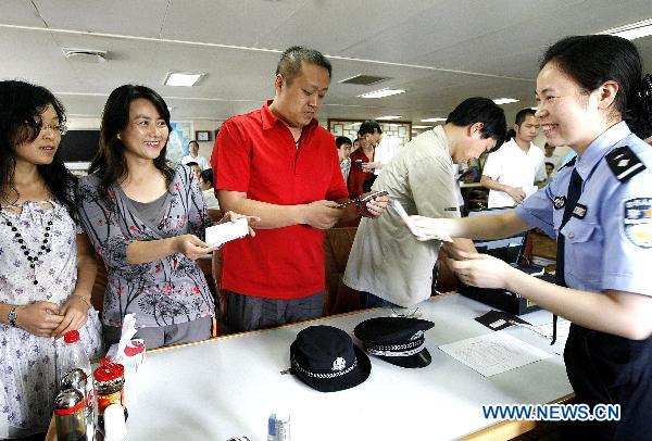 A frontier policewoman deals with entry procedures for members of the fourth Chinese Arctic scientific expedition team in Shanghai, east China, Sept. 19, 2010. 