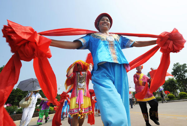 A traditional marriage ritual of the Zhuang ethnic group is performed, where the bride walks amid the bridesmaids on a street in Laibin, South China&apos;s Guangxi Zhuang autonomous region on Monday. A carnival focused on the culture of ethnic groups of Zhuang and Yao, which will last a week, kicked off on Sept 19 in Laibin, where cultural traditions such as costumes and dances will be exhibited. [Xinhua]