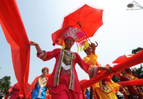 A traditional marriage ritual of the Zhuang ethnic group is performed, where the bride is walking along the red ropes on a street in Laibin, South China&apos;s Guangxi Zhuang autonomous region on Monday. [Xinhua]