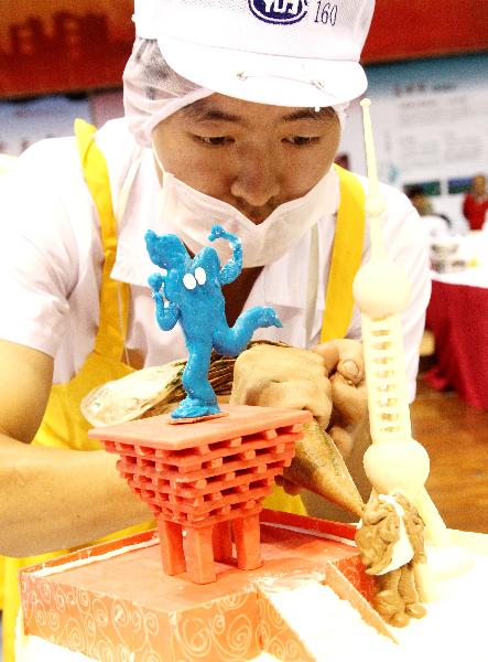 A contestant decorates his cake with the theme of World Expo Shanghai, at a cake decorating competition during the 5th China Suzhou Food Festival in Suzhou, east China's Jiangsu Province, Sept. 20, 2010. The five-day food festival kicked off on Monday, in which many activities would be held, such as cooking competition, cake decorating competition, snacks exhibition and so on.