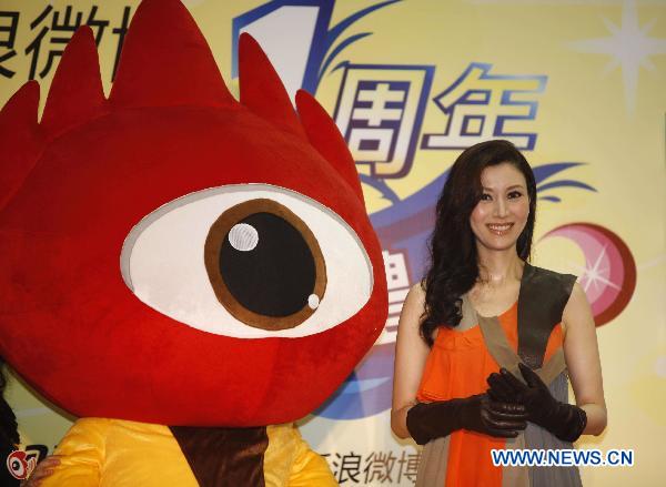Michelle Lee poses for photo with Sina Weibo mascot during Sina Weibo Anniversary Celebration in Hong Kong, south China, Sept. 20, 2010. Michelle also announced that she had been four-month pregnancy. Sina Weibo Monday presented the 'Sina Weibo Star-Users Awards' to celebrities and organizations who made the best use of Sina Weibo to exert a positive influence on the network and the society at large.