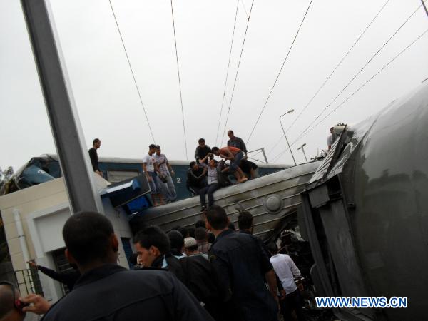 People stand at the spot of a train collision accident in southern Tunis Sept. 24, 2010. [Xinhua] 