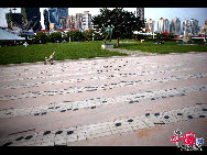 May Fourth Square, symbol of Qingdao, is a large public square located between the new municipal government building and Fushan Bay and composed of Shizhengting Square, the central square and the coastal park. Named after the nationwide protest May Fourth Movement that started in Qingdao, the square is best recognized by the large 'May Wind' red sculpture near the seaside. [Cheng Weidong/China.org.cn]