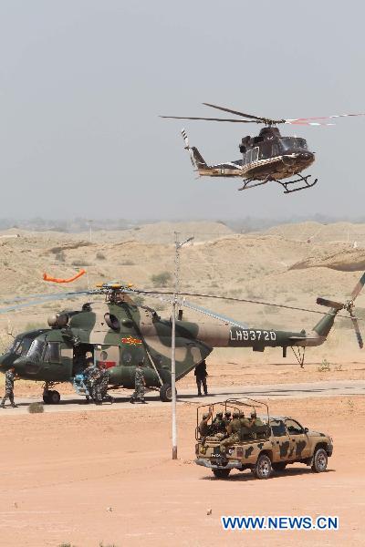 The Chinese helicopter rescue team is secured by Pakistan Army in Hyderabad, Pakistan, Sept. 25, 2010. The Chinese helicopter rescue team accomplished its first mission in flooded areas in Pakistan on Saturday. [Xinhua]