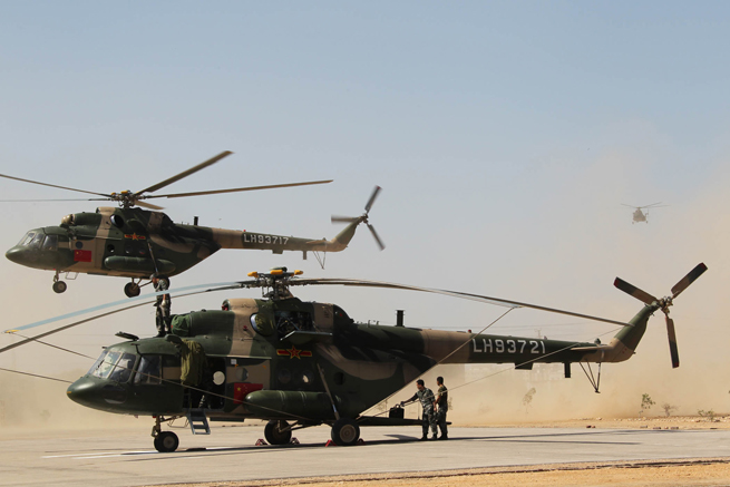 Helicopters of the Chinese helicopter rescue team return after a mission at a flooded area 160 km away from Hyderabad, Pakistan, Sept. 25, 2010. The Chinese helicopter rescue team accomplished its first mission in flooded areas in Pakistan on Saturday. [Xinhua]