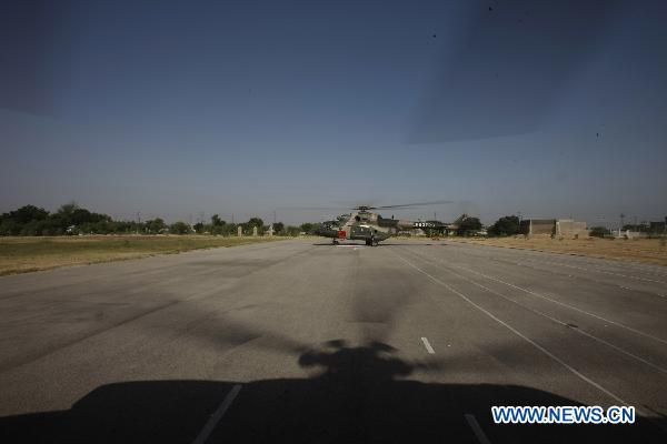 Helicopters of the Chinese helicopter rescue team return after a mission at a flooded area 160 km away from Hyderabad, Pakistan, Sept. 25, 2010. The Chinese helicopter rescue team accomplished its first mission in flooded areas in Pakistan on Saturday.[Li Xiang/Xinhua]