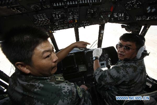 Shen Zhengwen(R), director in chief of the Chinese helicopter rescue team flies the helicopter to a flooded area 160 km away from Hyderabad, Pakistan, Sept. 25, 2010. The Chinese helicopter rescue team accomplished its first mission in flooded areas in Pakistan on Saturday.[Li Xiang/Xinhua]