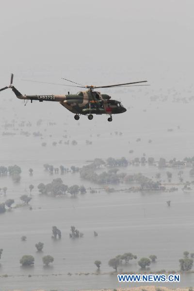A helicopter of the Chinese helicopter rescue team flies above a flooded area 160 km away from Hyderabad, Pakistan, Sept. 25, 2010. The Chinese helicopter rescue team accomplished its first mission in flooded areas in Pakistan on Saturday. [Li Xiang/Xinhua]
