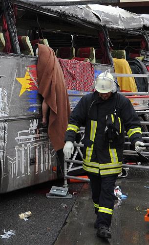 Emergency services stand next to the wreckage of a bus and a car following an accident on the A10 motorway near Schoenfeld south of Berlin September 26, 2010. [Xinhua/AFP]