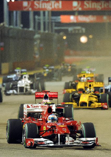 Ferrari Formula One driver Fernando Alonso of Spain leads the pack in the Singapore F1 Grand Prix at the Marina Bay circuit September 26, 2010. Alonso won the race. (Xinhua/AFP Photo)