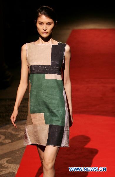 A model displays a creation as part of ROBERTO MUSSO spring-summer 2011 ready-to-wear collection during the Women's fashion week in Milan, Italy, Sept. 25, 2010.