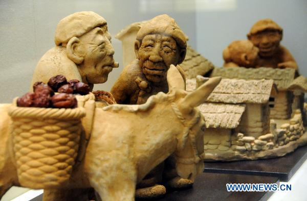 Mud sculptures are displayed at Hebei Folklore Museum in Shijiazhuang, capital of north China's Hebei Province, Sept. 26, 2010. The folklore museum started recently an exhibition of mud sculptures featuring country lives.