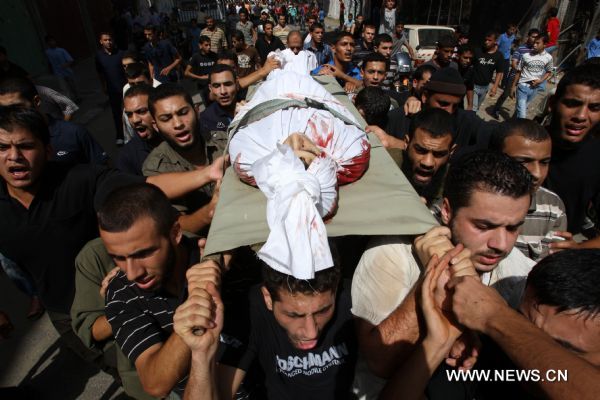 Palestinian mourners carry the body of Islamic Jihad militant Awni Abdelhadi, who was killed by Israeli shelling, during his funeral in the al-Bureij refugee camp, central Gaza Strip, Sept. 28, 2010. Three Palestinian militants from Islamic Jihad movement were killed on Monday night after they were targeted by an Israeli air-to-ground missile in central Gaza Strip, medics and witnesses said. [Xinhua]