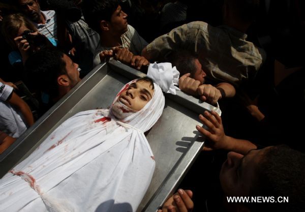 Palestinian mourners carry the body of Islamic Jihad militant Awni Abdelhadi, who was killed by Israeli shelling, during his funeral in the al-Bureij refugee camp, central Gaza Strip, Sept. 28, 2010. Three Palestinian militants from Islamic Jihad movement were killed on Monday night after they were targeted by an Israeli air-to-ground missile in central Gaza Strip, medics and witnesses said. [Xinhua] 