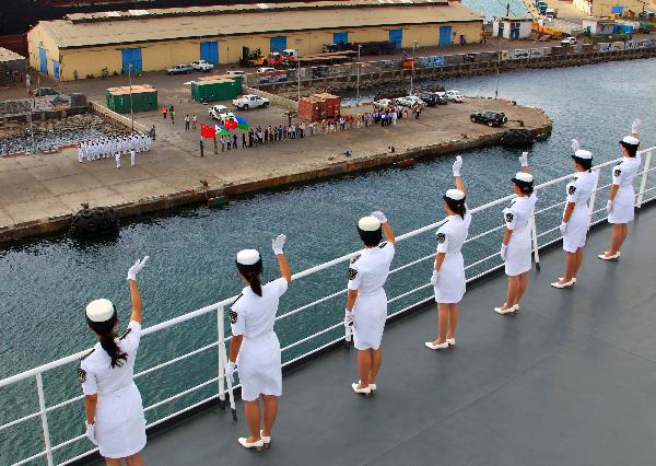 Crew members of China's hospital ship Peace Ark waves goodbye on the deck as the ship leaves the port of Djibouti, Sept. 29, 2010. The Peace Ark left for Kenya on Wednesday after providing medical services for local residents in Djibouti for a week. [Xinhua photo]