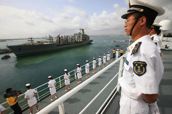 Crew members of China's hospital ship Peace Ark stand on the deck as the ship leaves the port of Djibouti, Sept. 29, 2010. The Peace Ark left for Kenya on Wednesday after providing medical services for local residents in Djibouti for a week. [Xinhua photo]