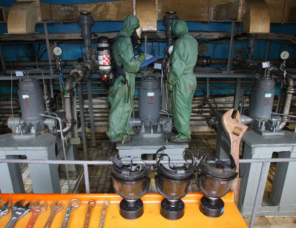 Photo taken on Sept. 29, 2010 shows scientists examine the fueling system for the Long March CZ-3C rocket, which will boost Chang'e II to a trans-lunar orbit, in Xichang Satellite Launch Center in Xichang, southwest China's Sichuan Province. 