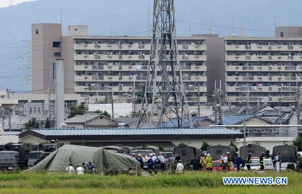 A Japanese Ground Self-Defense Force (GSDF) chopper is covered after crashing on the ground in the city of Yao in western Japan's Osaka prefecture Oct. 3, 2010. A Japanese Ground Self-Defense Force (GSDF) chopper with four people on board crashed on Sunday in the city of Yao in western Japan's Osaka prefecture, leaving the four injured, the Kyodo News reported. [Xinhua/Kyodo]