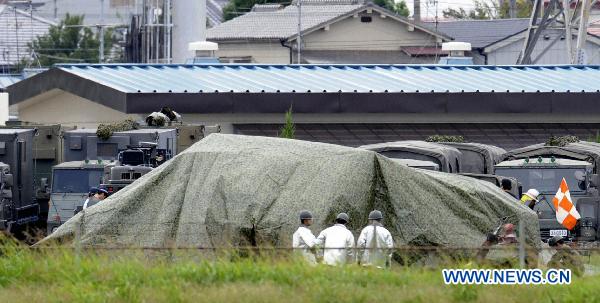 A Japanese Ground Self-Defense Force (GSDF) chopper is covered after crashing on the ground in the city of Yao in western Japan's Osaka prefecture Oct. 3, 2010. A Japanese Ground Self-Defense Force (GSDF) chopper with four people on board crashed on Sunday in the city of Yao in western Japan's Osaka prefecture, leaving the four injured, the Kyodo News reported. [Xinhua/Kyodo]