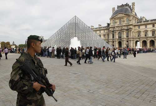 French soldiers patrol around the Louvre museum in Paris on Sunday. [Agencies]