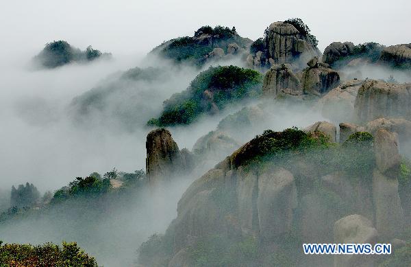 The undated photo shows the peaks of Tailao Mountain within the Ningde Geopark in southeast China&apos;s Fujian Province. The UNESCO held a meeting on world geoparks at the Greek island of Lesvos Oct. 3, 2010, in which Ningde Geopark was list in UNESCO&apos;s Global Geopark Network (GGN). The Ningde Geopark, covering an area of 2639.443 square kilometers, is an integration of various landforms such as granite landform, volcanic landform, erosion riverbed landform, and erosion coastal landform. [Lai Jianqiang/Xinhua]