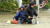 People ride in rain in Sanya, south China's Hainan Province, Oct. 5, 2010. Heavy rains will hit Leizhou Peninsula and Hainan Province where heavy rain has pounded for four days and the average precipitation has exceeded 200 mm in most parts, according to the local weather bureau. [Xinhua/Xu Qintao]