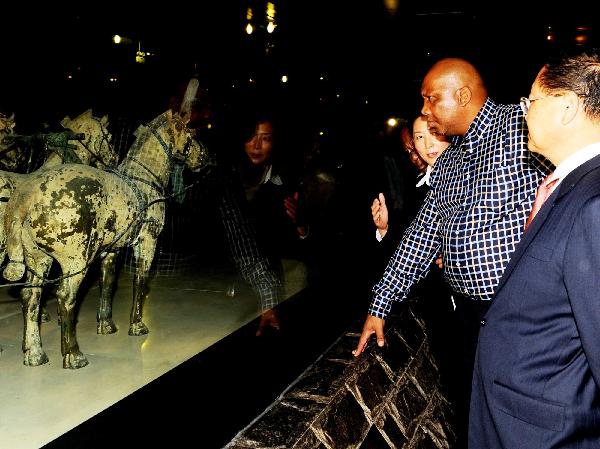 Lesotho's King Letsie III (2nd R) looks at bronze chariots and horses while visiting the Museum of the Terra-cotta Warriors and Horses of Qin Shihuang in Xi'an, capital of northwest China's Shaanxi Province, Oct. 5, 2010. Letsie III arrived in Xi'an for a visit Tuesday. [Xinhua/Liu Xiao]