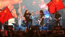 A singer performs during a beach music party in Zhuhai, south China's Guangdong Province, Oct. 4, 2010. Bands from home and abroad performed during the party held on the Jida bathing beach on Monday. [Xinhua/Li Jianshu]