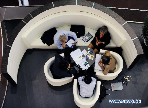 Representatives are seen working during a break of the UN Climate Change Conference held in north China's Tianjin Municipality, Oct. 5, 2010. [Xinhua/Yue Yuewei]