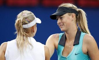 Maria Sharapova (R) of Russia greets her compatriot Elena Vesnina after their second round match of women's singles in 2010 China Tennis Open Tournament in Beijing, China, Oct. 5, 2010. Sharapova lost 0-2. [Xinhua/Wang Lili]