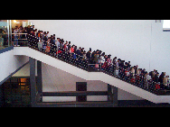 Passengers walk out of the Suzhou railway station in East China's Jiangsu province, Oct 7, 2010.  [Xinhua]