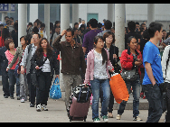 Passengers walk out of the Longtousi bus station in Chongqing province, Oct 7, 2010.  [Xinhua]