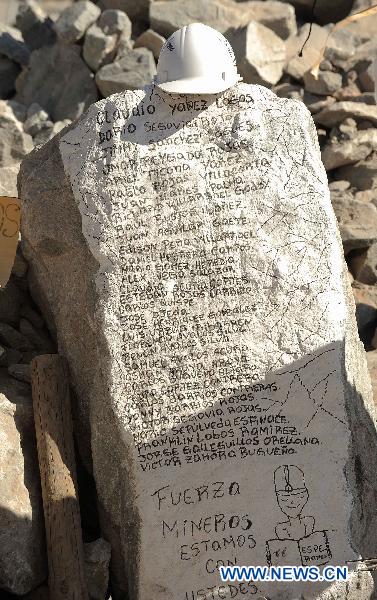List of the miners that still trapped underground are seen on a stone at the San Jose Mine, 800 km north of the Chilean capital Santiago on Oct. 6, 2010. The 33 miners have been trapped 700 meters underground for two months by far as the rescue operation hopefully enters its final phase. [Xinhua]