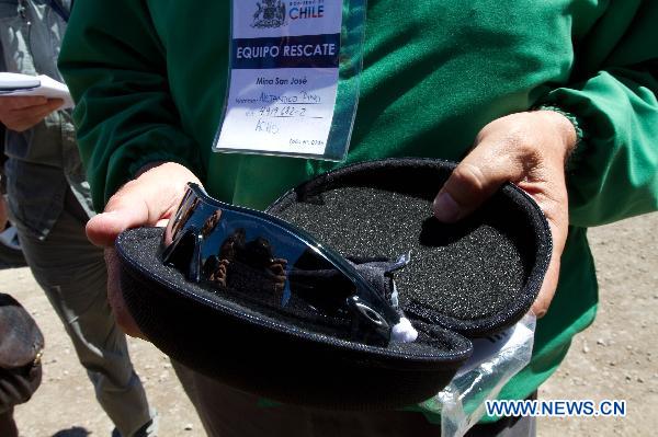 Alejandro Pino, one of the rescuers, holds a pair of sunglasses that prepared for protecting rescued miners&apos; eyes at the San Jose Mine, 800 km north of the Chilean capital Santiago on Oct. 7, 2010. The 33 miners have been trapped 700 meters underground for two months by far as the rescue operation hopefully enters its final phase. [Xinhua]