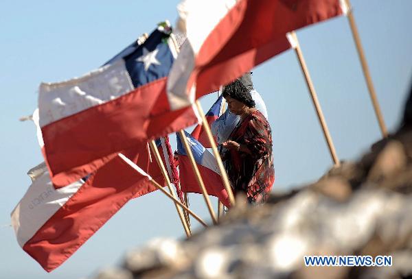 A woman prays for the miners that still trapped underground at the San Jose Mine, 800 km north of the Chilean capital Santiago on Oct. 6, 2010. The 33 miners have been trapped 700 meters underground for two months by far as the rescue operation hopefully enters its final phase. [Xinhua]