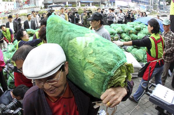 South Koreans buy cabbages subsidized by Seoul city hall office, at a market in Seoul October 5, 2010. [Xinhua/Reuters]