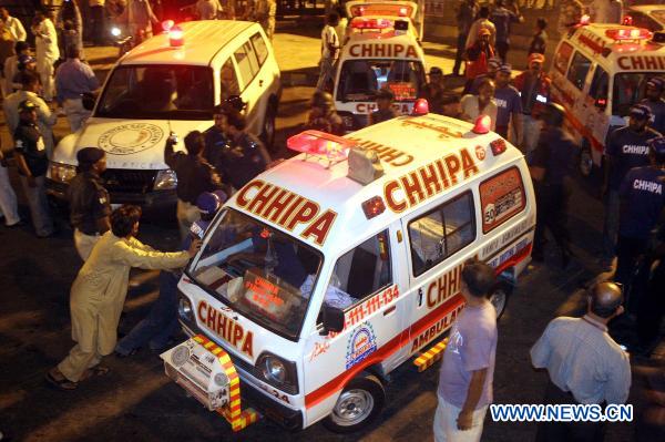 Ambulances park outside a shrine after blasts in Pakistan's southern port city of Karachi, Oct. 7, 2010. At least 14 people were killed and 70 others injured in two suicide blasts that took place Thursday night at a shrine. [Arshad/Xinhua]