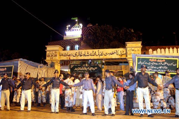 Police cordon off the blast site at a shrine in Pakistan's southern port city of Karachi, Oct. 7, 2010. At least 14 people were killed and 70 others injured in two suicide blasts that took place Thursday night at a shrine. [rshad/Xinhua]