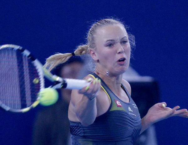 Caroline Wozniacki of Denmark hits a return against Petra Kvitova of the Czech Republic during the women's singles third round match at the China Open tennis tournament in Beijing, capital of China, Oct. 7, 2010. (Xinhua/Chen Jianli) 