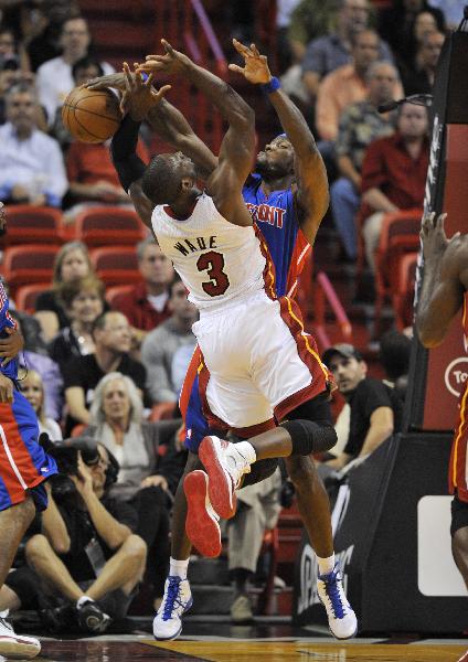Miami Heat guard Dwyane Wade has his shot stopped by Detroit Pistons center Ben Wallace during the first quarter of a preseason NBA basketball game, Tuesday, Oct. 5, 2010, in Miami. (Xinhua/Reuters Photo) 