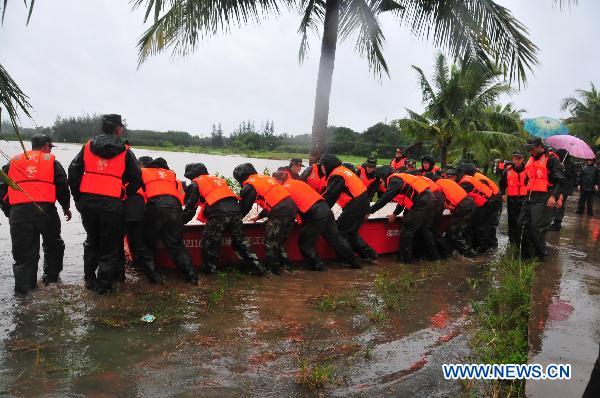 Soldiers push a rescue speed boat to the water in Haikou, capital of south China&apos;s Hainan Province, Oct. 7, 2010. 