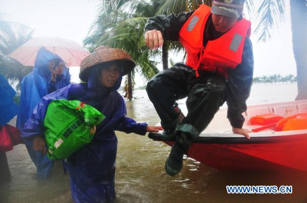 A soldier jumps into water to rescue villagers at the Sanjiang farm in Haikou, capital of south China&apos;s Hainan Province, Oct. 7, 2010. 