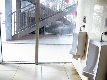 A public toilet in Hankou, Hubei Province has glass walls that allow passers-by a full view. Most people admit to having a bashful bladder.