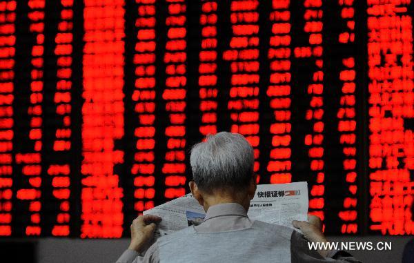 An investor sits in a stock exchange in Hangzhou, capital of east China's Zhejiang Province, Oct. 8, 2010. 