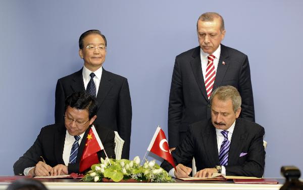 Chinese Premier Wen Jiabao (L, back) and Turkish Prime Minister Recep Tayyip Erdogan (R, back) attend a signing ceremony in Ankara, capital of Turkey, Oct. 8, 2010, as officials from both sides signed eight pacts to improve economic and cultural cooperation. [Xie Huanchi/Xinhua]