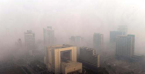 Photo taken on Oct. 9, 2010 shows buildings in heavy fog in Nanjing, east China&apos;s Jiangsu Province.Many places in China witnessed heavy fog on Saturday. [Xinhua]